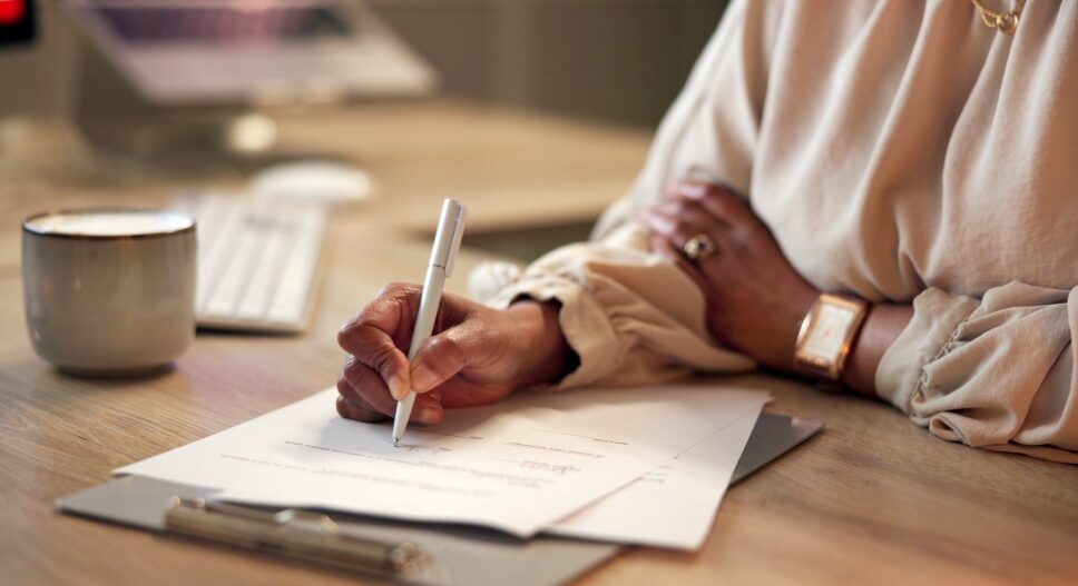 Woman signing paperwork