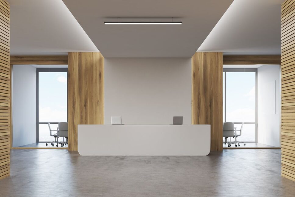 Two-conference-rooms-surrounding-reception-desk-with-two-laptops